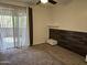 Bedroom includes sliding glass door to patio, ceiling fan and wood accent wall at 1720 E Thunderbird Rd # 2087, Phoenix, AZ 85022