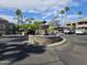 Beautiful water fountain feature in community with desert landscaping, palm trees, and covered parking at 1720 E Thunderbird Rd # 2087, Phoenix, AZ 85022