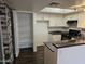 Bright kitchen featuring white cabinets, dark countertops, pantry and stainless-steel sink at 1720 E Thunderbird Rd # 2087, Phoenix, AZ 85022