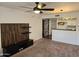 Living room boasts modern ceiling fan, wood accent wall and open kitchen view at 1720 E Thunderbird Rd # 2087, Phoenix, AZ 85022