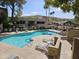 Community pool featuring comfortable lounge chairs, clear blue water, and a beautifully landscaped surrounding area at 1720 E Thunderbird Rd # 2087, Phoenix, AZ 85022