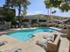 Community pool featuring comfortable lounge chairs, clear blue water, and a beautifully landscaped surrounding area at 1720 E Thunderbird Rd # 2087, Phoenix, AZ 85022