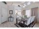 Bright dining room featuring tile floors, high ceilings, modern furniture, and plenty of natural light at 17224 N Zuni Trl, Surprise, AZ 85374