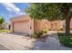Charming single-story home featuring a two-car garage and a neatly landscaped front yard with mature trees at 17224 N Zuni Trl, Surprise, AZ 85374