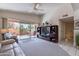 Inviting living room with a large media center, comfortable seating, and sliding glass doors to the patio at 17224 N Zuni Trl, Surprise, AZ 85374