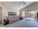 Comfortable living room with plush seating, a ceiling fan, and access to the patio via a sliding glass door at 17224 N Zuni Trl, Surprise, AZ 85374