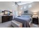 Serene main bedroom with vaulted ceilings, soft carpet, and ample natural light from multiple windows at 17224 N Zuni Trl, Surprise, AZ 85374