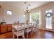 Dining room with natural light, a large table, white chairs and ample space for entertaining guests at 1787 E Sattoo Way, Queen Creek, AZ 85140