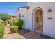 Welcoming front entrance with decorative tile archway, desert landscaping, and stylish outdoor lighting at 1787 E Sattoo Way, Queen Creek, AZ 85140