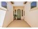 Inviting covered porch with a light green door adorned with a wreath and flanked by potted plants at 1787 E Sattoo Way, Queen Creek, AZ 85140