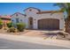 Charming home featuring a desert landscaped front yard, arched entryway, and a two-car garage at 1787 E Sattoo Way, Queen Creek, AZ 85140
