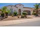 Inviting single-story home showcasing desert landscaping, an arched entryway, and a two-car garage at 1787 E Sattoo Way, Queen Creek, AZ 85140