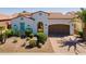 Stunning home showcasing an arched entry, desert landscaping and a spacious two-car garage at 1787 E Sattoo Way, Queen Creek, AZ 85140