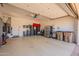 Spacious garage with ample storage cabinets, epoxy flooring and automatic door, providing a functional space at 1787 E Sattoo Way, Queen Creek, AZ 85140