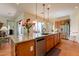 Bright kitchen features granite countertops, stainless steel appliances, and tile flooring at 1787 E Sattoo Way, Queen Creek, AZ 85140