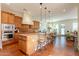 Spacious kitchen boasts stainless steel appliances, a large island with barstool seating, and stylish pendant lighting at 1787 E Sattoo Way, Queen Creek, AZ 85140