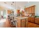 Stylish kitchen features granite countertops, a center island with barstool seating, and stainless steel appliances at 1787 E Sattoo Way, Queen Creek, AZ 85140