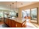 Open concept kitchen with granite countertops and outdoor patio access at 1787 E Sattoo Way, Queen Creek, AZ 85140