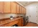 Well-equipped laundry room features modern washer/dryer, ample cabinetry, and tiled countertops at 1787 E Sattoo Way, Queen Creek, AZ 85140