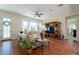 Cozy living room with tile floors, a comfortable sofa, and an entertainment center at 1787 E Sattoo Way, Queen Creek, AZ 85140