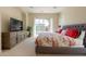 Spacious main bedroom featuring a television, decorative dresser and outside views at 1787 E Sattoo Way, Queen Creek, AZ 85140