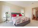 Serene main bedroom boasting decorative headboard, bright windows, and side tables at 1787 E Sattoo Way, Queen Creek, AZ 85140