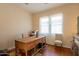 Bright office space featuring a wooden desk, chair, and natural light from windows at 1787 E Sattoo Way, Queen Creek, AZ 85140