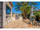 Backyard area featuring a built-in stainless steel grill and travertine stone patio surrounded by lush landscaping at 1787 E Sattoo Way, Queen Creek, AZ 85140