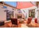 Cozy outdoor patio with fireplace, seating, and string lights at 1787 E Sattoo Way, Queen Creek, AZ 85140