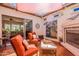 Relaxing outdoor patio with seating, fireplace, and access to the living room at 1787 E Sattoo Way, Queen Creek, AZ 85140