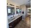 Dual sink bathroom with tile floors and a view of walk-in closet at 1810 N Mcdonald St, Casa Grande, AZ 85122