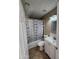 Standard bathroom with a vanity, tile floor, toilet, and shower-tub combo with a wave-patterned shower curtain at 1810 N Mcdonald St, Casa Grande, AZ 85122