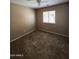 Bedroom with tan walls, carpet floor, a window, and a ceiling fan with light fixture at 1810 N Mcdonald St, Casa Grande, AZ 85122