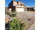 Inviting two-story home featuring a covered porch, a neutral color palette and an attached two car garage at 1810 N Mcdonald St, Casa Grande, AZ 85122