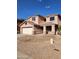 Inviting two-story home featuring a covered porch, a neutral color palette and an attached two car garage at 1810 N Mcdonald St, Casa Grande, AZ 85122