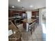 Well-equipped kitchen featuring stainless steel appliances, granite counters, and a central island with breakfast bar seating at 1810 N Mcdonald St, Casa Grande, AZ 85122