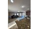 Open-concept space showcasing a fireplace and a seamless transition to the kitchen and dining area at 1810 N Mcdonald St, Casa Grande, AZ 85122