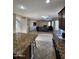 Open-concept space showcasing a fireplace and a seamless transition to the kitchen and dining area at 1810 N Mcdonald St, Casa Grande, AZ 85122
