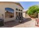 View of backyard featuring gravel, patio, a grill, and desert landscaping at 18221 N 49Th Pkwy, Glendale, AZ 85308