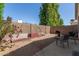 View of backyard featuring gravel, patio, a grill, and desert landscaping at 18221 N 49Th Pkwy, Glendale, AZ 85308