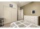 Bright bedroom features a white dresser, neutral walls, and closet with sliding doors at 18221 N 49Th Pkwy, Glendale, AZ 85308