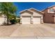 Traditional home featuring a two-car garage, desert landscaping, and neutral color palette at 18221 N 49Th Pkwy, Glendale, AZ 85308