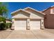 Home featuring a two-car garage, desert landscaping, and neutral color palette at 18221 N 49Th Pkwy, Glendale, AZ 85308