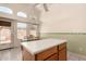 Eat in kitchen features white tile floor, island, and dinette with bright windows at 18221 N 49Th Pkwy, Glendale, AZ 85308