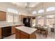 Open concept kitchen featuring a center island with neutral countertops and modern appliances at 18221 N 49Th Pkwy, Glendale, AZ 85308