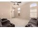 Spacious living room featuring neutral walls and carpet flooring, accompanied by vaulted ceilings at 18221 N 49Th Pkwy, Glendale, AZ 85308