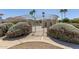 Secured access to the community pool, surrounded by lush landscaping and desert trees at 18221 N 49Th Pkwy, Glendale, AZ 85308
