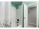 Bright bathroom featuring a white shower-tub combo and an open door at 1829 E Decatur St, Mesa, AZ 85203