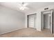Bedroom features a ceiling fan, closet with built-in shelving, and access to an ensuite at 1829 E Decatur St, Mesa, AZ 85203