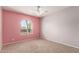 Bright bedroom features a modern ceiling fan and an arched window offering a view of palm trees at 1829 E Decatur St, Mesa, AZ 85203